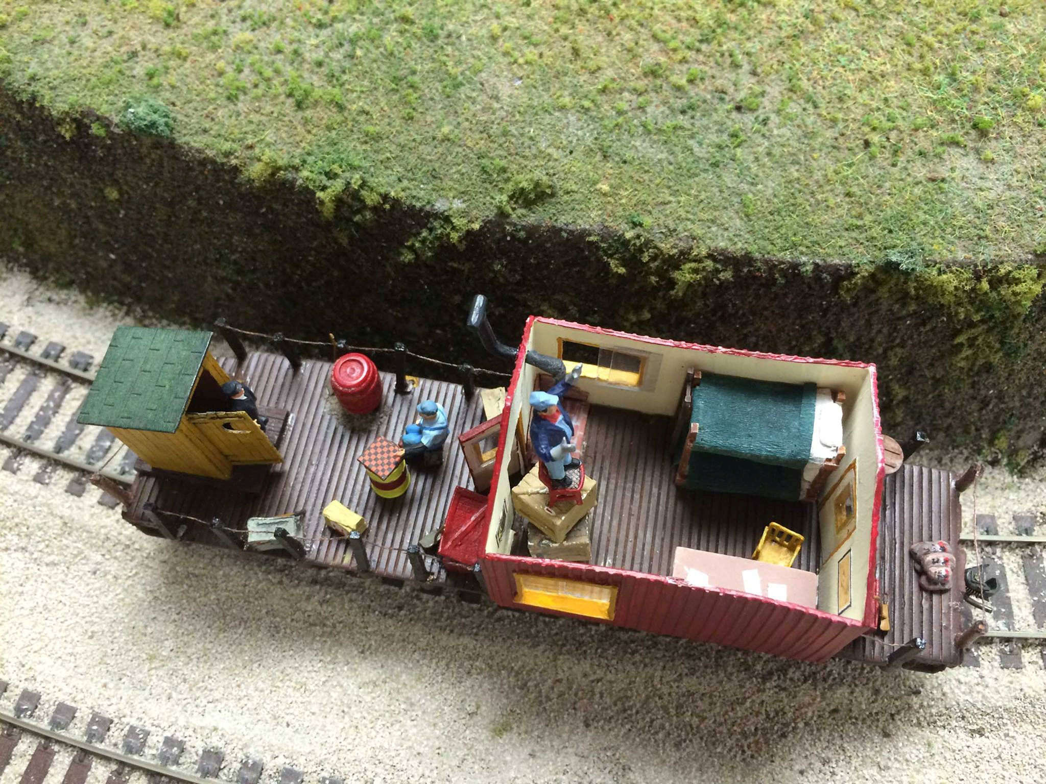 Model train caboose with detailed interior and figures at Oshawa Pine Ridge Model Railroaders Club.
