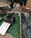 Oshawa Pine Ridge Model Railroaders club members fine-tuning a rail layout with intricate details.