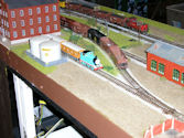 An overhead view of a multi-level HO scale railway layout with bridges and tunnels.