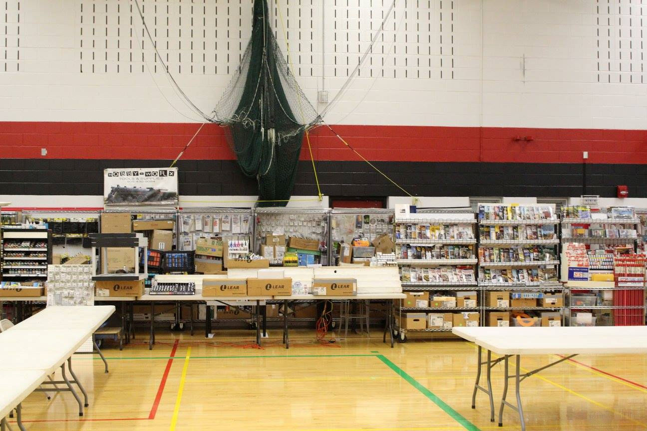  Large model train exhibition layout with trees, houses, and multiple railway tracks.