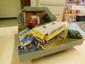 A model train traveling through a snow-covered winter landscape.