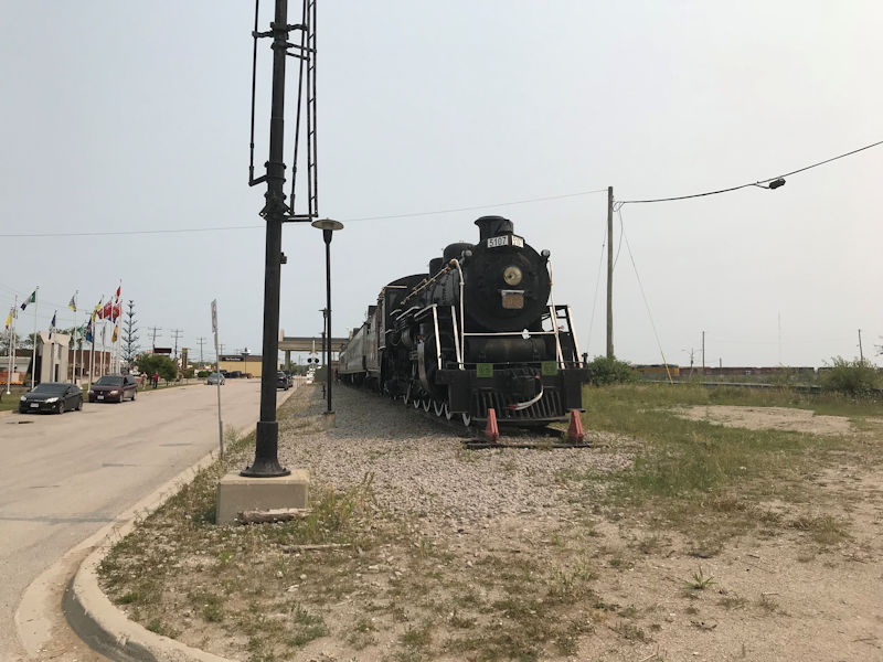Welcome to the Ron Morel Memorial Museum in Kapuskasing Ontario Canada

This site's collection focuses on the Kapuskasing region from 1914 to the present. The museum is housed in two Canadian National Railway coaches, an engine and a caboose. There is a permanent exhibit on Kapuskasing's World War I internment camp ( www.cdli.ca/monuments/on/kapplaq.htm ), and new exhibits every season on various aspects of Kapuskasing. Working HO-gauge and N-gauge railway models are sure to delight young and older visitors alike.

The Ron Morel Memorial Museum, housed in locomotive #5107, was founded in 1971 by the late Ron Morel Sr. whose vision was to showcase two of his passions -local history and trains. The museum has something for everyone.
