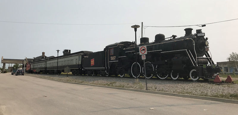 Welcome to the Ron Morel Memorial Museum in Kapuskasing Ontario Canada

This site's collection focuses on the Kapuskasing region from 1914 to the present. The museum is housed in two Canadian National Railway coaches, an engine and a caboose. There is a permanent exhibit on Kapuskasing's World War I internment camp ( www.cdli.ca/monuments/on/kapplaq.htm ), and new exhibits every season on various aspects of Kapuskasing. Working HO-gauge and N-gauge railway models are sure to delight young and older visitors alike.

The Ron Morel Memorial Museum, housed in locomotive #5107, was founded in 1971 by the late Ron Morel Sr. whose vision was to showcase two of his passions -local history and trains. The museum has something for everyone.
