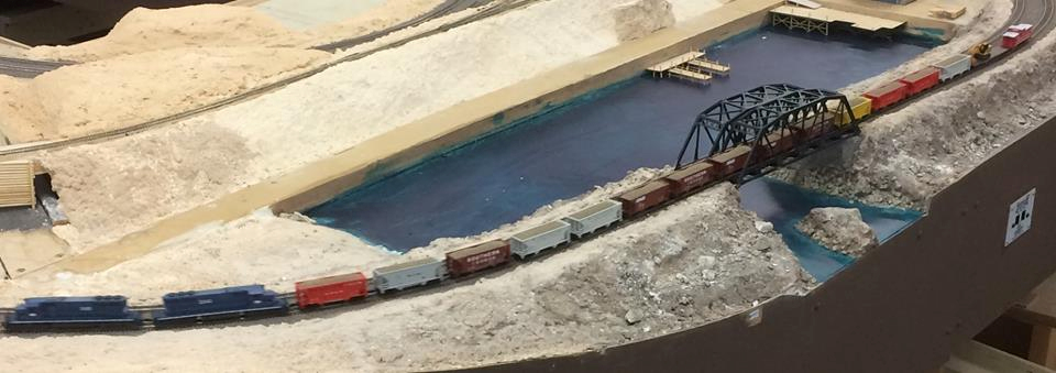 Welcome to the Los Angeles N-Scale Association, operators of East Valley Lines Model Railroad club located since 1979 in the Travel Town Museum at Griffith Los Angeles, California. View pitchers of the East Valley Lines N Scale Model Railroad club and see what they have done to their N scale layout. They operate one of the largest N-Scale layouts in the world. This is just a brief trip on the East Valley Lines' trackage. As you observe closely, there are lots of details to enjoy. This is truly a labor of love, involving countless hours, money and the talents of the many N-Scale modelers dedicated to the memory of great railroads. Brought to you to by www.krafttrains.com