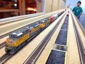 Welcome to the Los Angeles N-Scale Association, operators of East Valley Lines Model Railroad located since 1979 in the Travel Town Museum at Griffith Park. View pitchers of the East Valley Lines N Scale Model Railroad and see what they have done to their N scale layout. They operate one of the largest N-Scale layouts in the world. This is just a brief trip on the East Valley Lines' trackage. As you observe closely, there are lots of details to enjoy. This is truly a labor of love, involving countless hours, money and the talents of the many N-Scale modelers dedicated to the memory of great railroads. Brought to you to by www.krafttrains.com