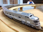 Welcome to the Los Angeles N-Scale Association, operators of East Valley Lines Model Railroad located since 1979 in the Travel Town Museum at Griffith Park. View pitchers of the East Valley Lines N Scale Model Railroad and see what they have done to their N scale layout. They operate one of the largest N-Scale layouts in the world. This is just a brief trip on the East Valley Lines' trackage. As you observe closely, there are lots of details to enjoy. This is truly a labor of love, involving countless hours, money and the talents of the many N-Scale modelers dedicated to the memory of great railroads. Brought to you to by www.krafttrains.com
